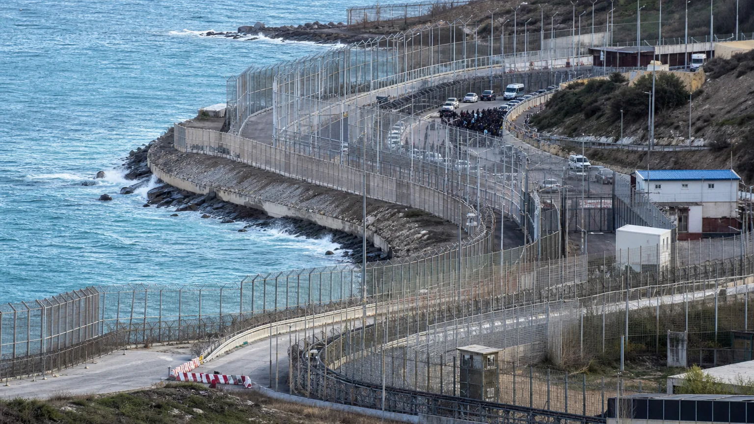 Silueta de una figura militar de alto rango de espaldas mirando un gran mapa de España con Ceuta y Melilla resaltadas, en un entorno de oficina sobrio y profesional que sugiere seguridad nacional.